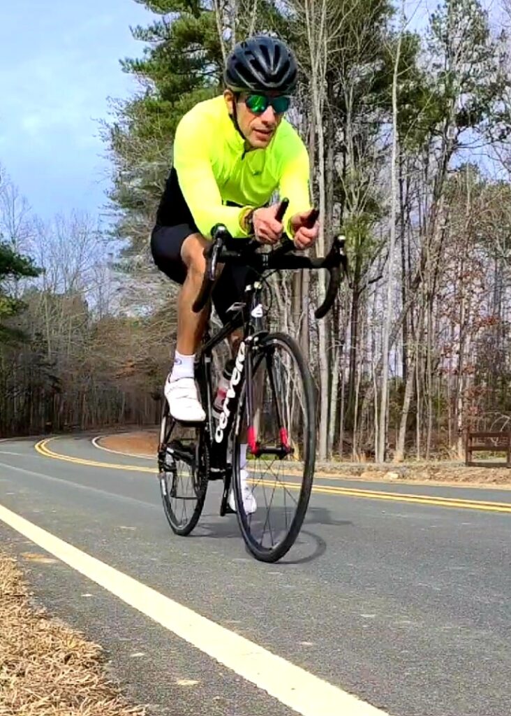 Dr. Oscar Cornelio riding a black road bike